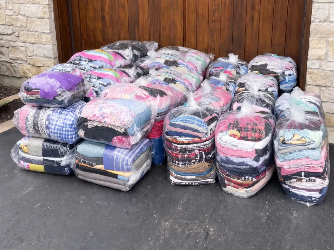 Clean laundry packed in air-tight bags, stacked and ready at the garage door
