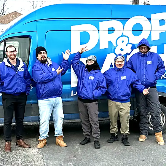 Five Drop & Dash drivers in front of a branded delivery van
